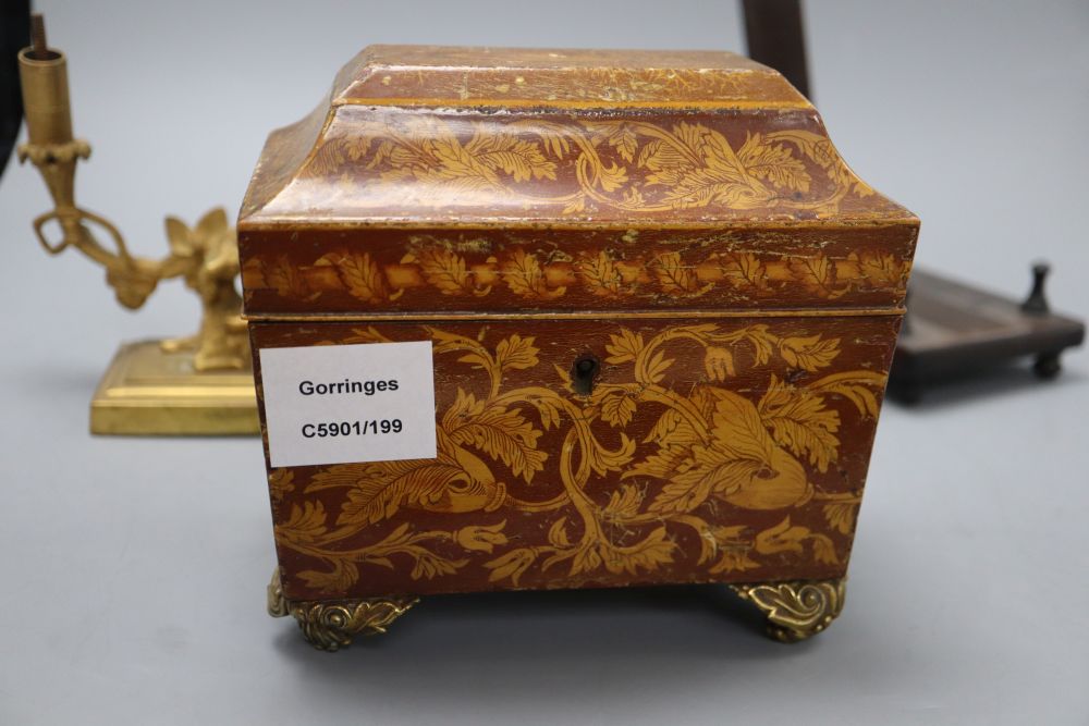 A William IV penwork tea caddy, a pair of ormolu Bacchanalian cherub candlesticks, lacking sconces and a hardwood dish stand